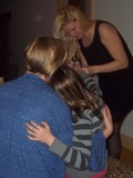 photo of melanie painting little girl's nails and mother holding the daughter