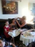 girls getting their makeup done at spa theme party